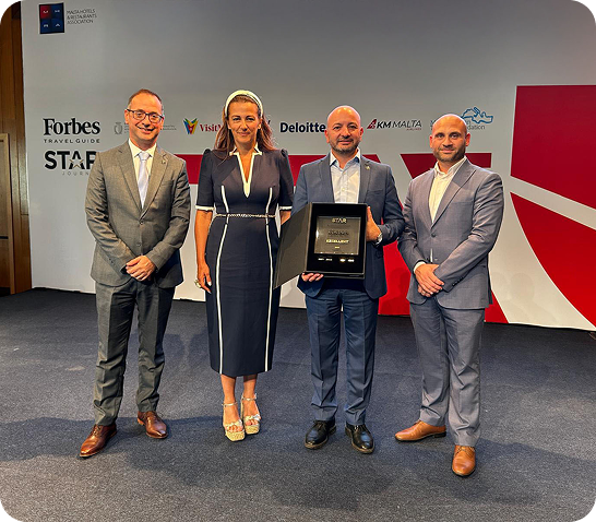 AX Hotels team members holding achievements