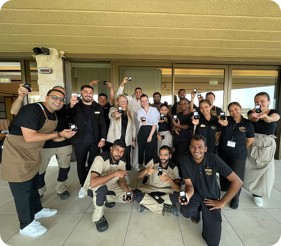 AX Hotel employees receiving pins for their contribution to hotel jobs